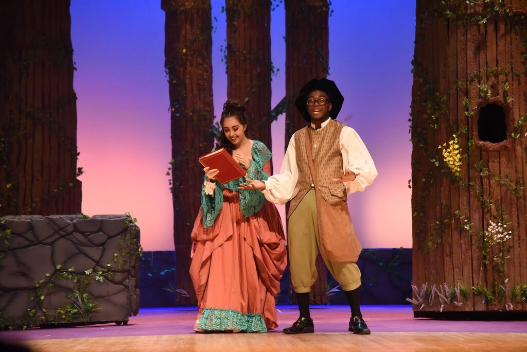 Malik performing a scene in a forest set