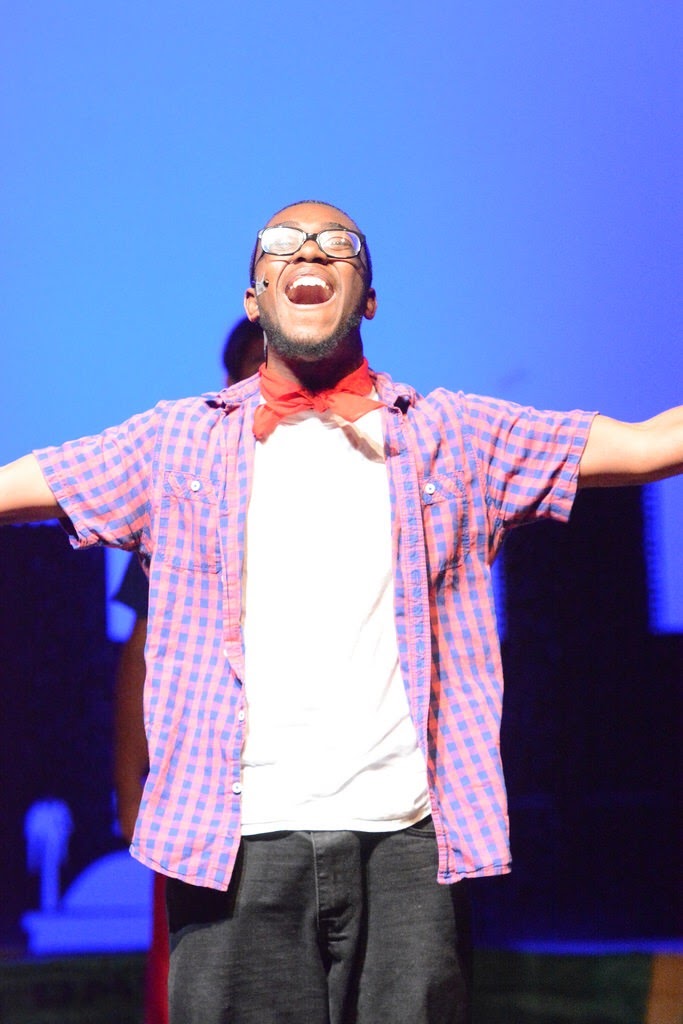Malik mid-song under blue stage light